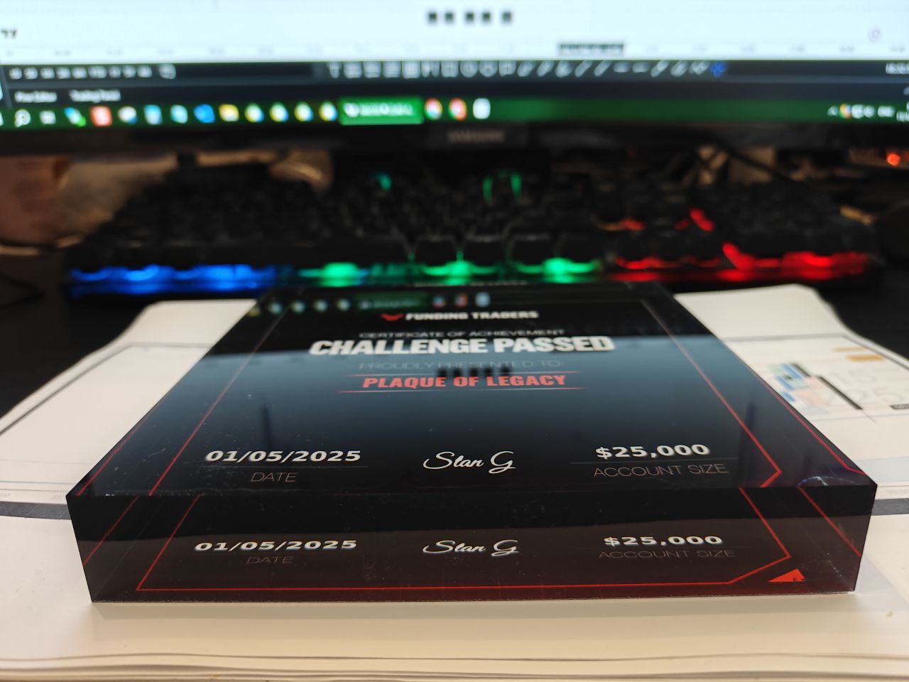 Acrylic plaque award with 'Challenge Passed' text on a desk.