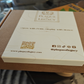 Product packaging with 'Plaque Legacy' branding and QR code on a cardboard box.